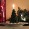 A green, beeswax candle shaped like a Christmas tree. The candle has detailed branches and a pointed top.