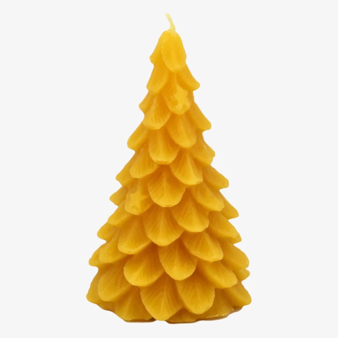 A yellow, beeswax candle shaped like a Christmas tree. The candle has detailed branches and a pointed top.