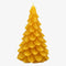 A yellow, beeswax candle shaped like a Christmas tree. The candle has detailed branches and a pointed top.