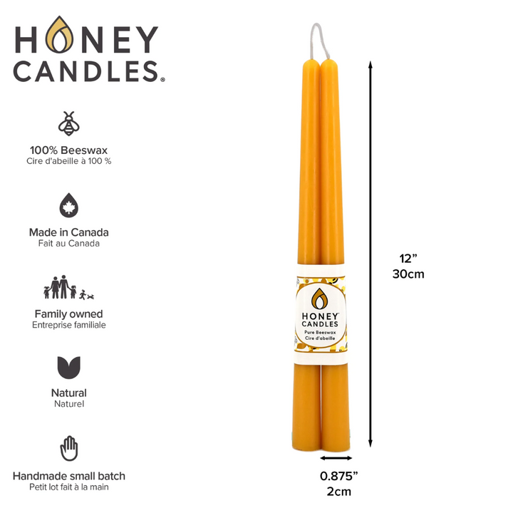 Two yellow beeswax candles standing upright, tied together with a string. The candles have a label that says 
