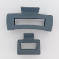 Two gray hair clips on a white background
