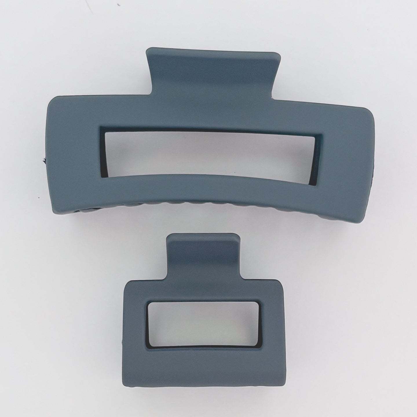 Two gray hair clips on a white background