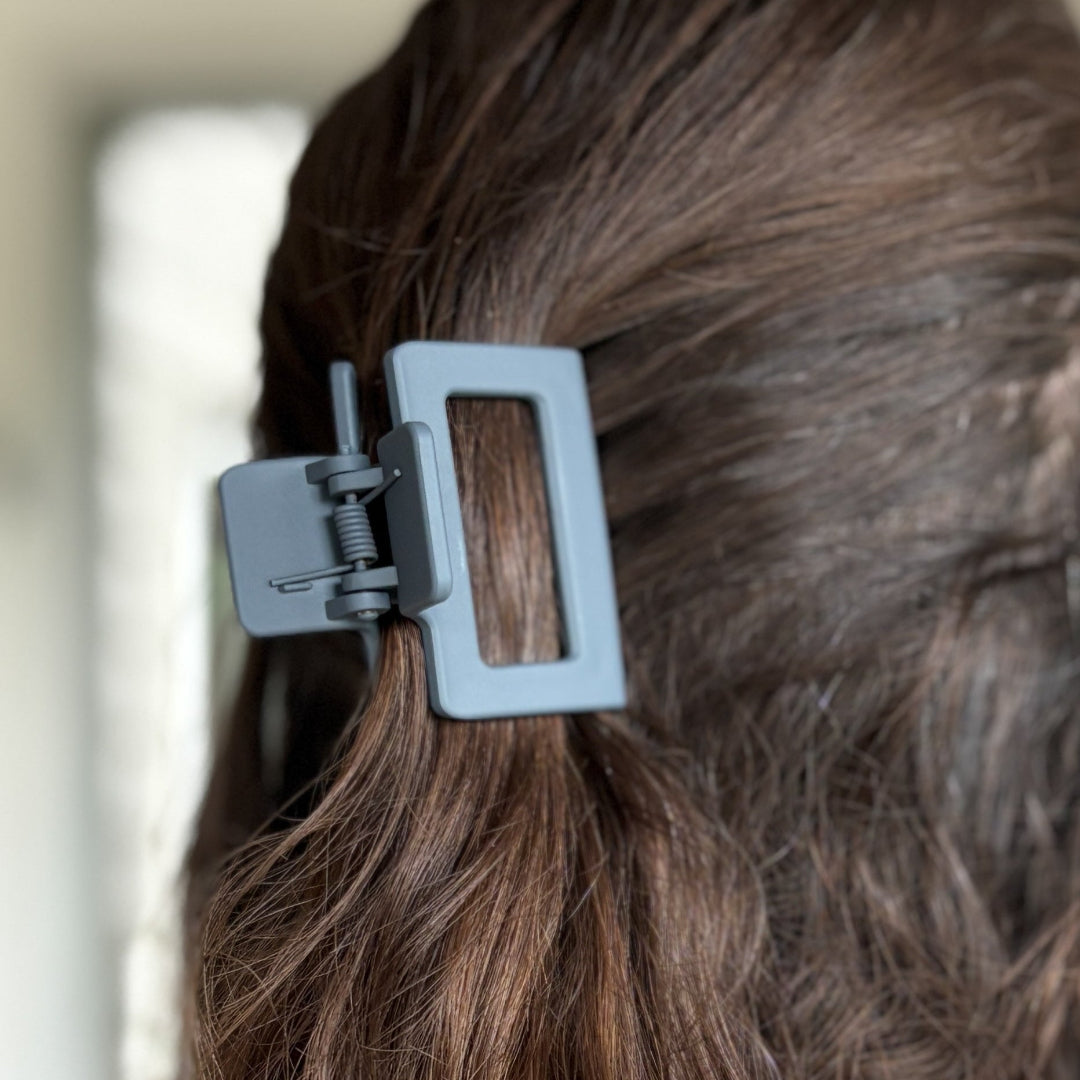 Close-up of a hair clip in a person's hair with a blurred background