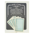 Card with playing cards and text 'Pick a card, an affectionate prediction for the enchanting newlyweds' on a dark background.
