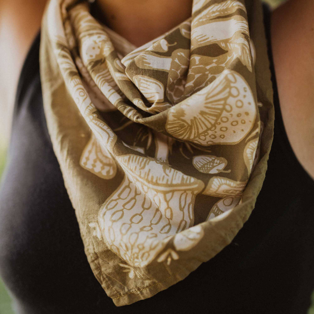 Close-up of a patterned scarf with a neutral color scheme on a blurred background