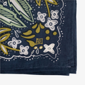 A navy blue bandana with a floral pattern in shades of green and yellow. The pattern features stylized flowers, leaves, and small dots.