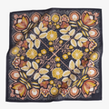 A navy blue bandana with a floral pattern. The pattern features stylized flowers, leaves, and berries in shades of yellow, orange, and pink.