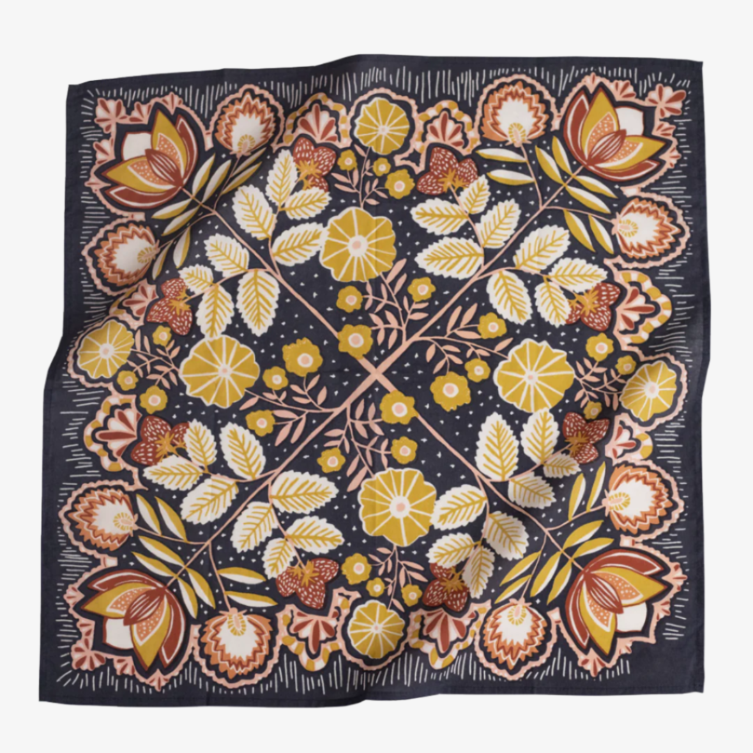 A navy blue bandana with a floral pattern. The pattern features stylized flowers, leaves, and berries in shades of yellow, orange, and pink.