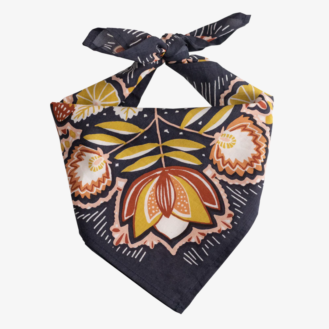 A navy blue bandana with a floral pattern. The pattern features stylized flowers, leaves, and berries in shades of yellow, orange, and pink.