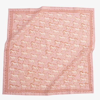 A pink bandana with a pattern of white galloping horses. The horses are evenly spaced and face in various directions.