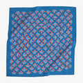 A blue bandana with a floral pattern. The pattern features small red flowers with white centers and white leaves.