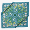 A blue bandana with a floral pattern. The pattern features white flowers with yellow centers and green leaves. The border of the bandana has a decorative, repeating pattern.