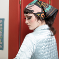 A black bandana with a mystical pattern. The pattern features a Ouija board design with hands pointing to letters and numbers, along with celestial symbols like moons and stars.