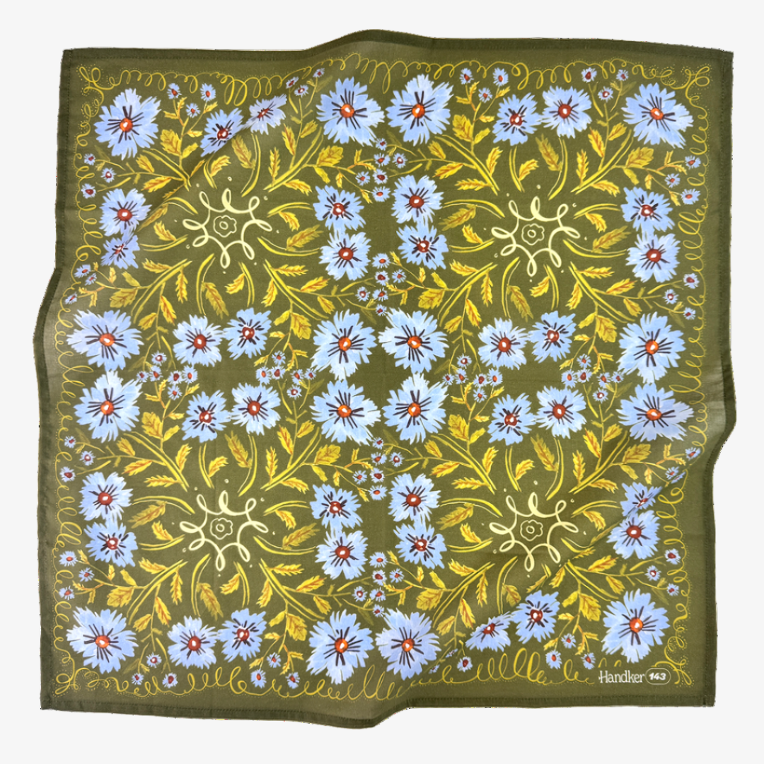 Floral patterned fabric with blue flowers and green leaves on a white background