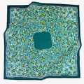 Green patterned fabric with colorful floral design on a white background
