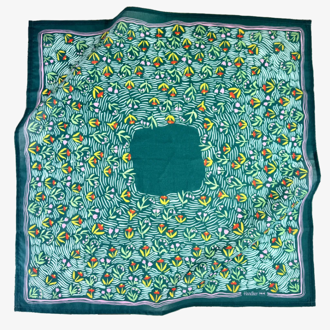Green patterned fabric with colorful floral design on a white background