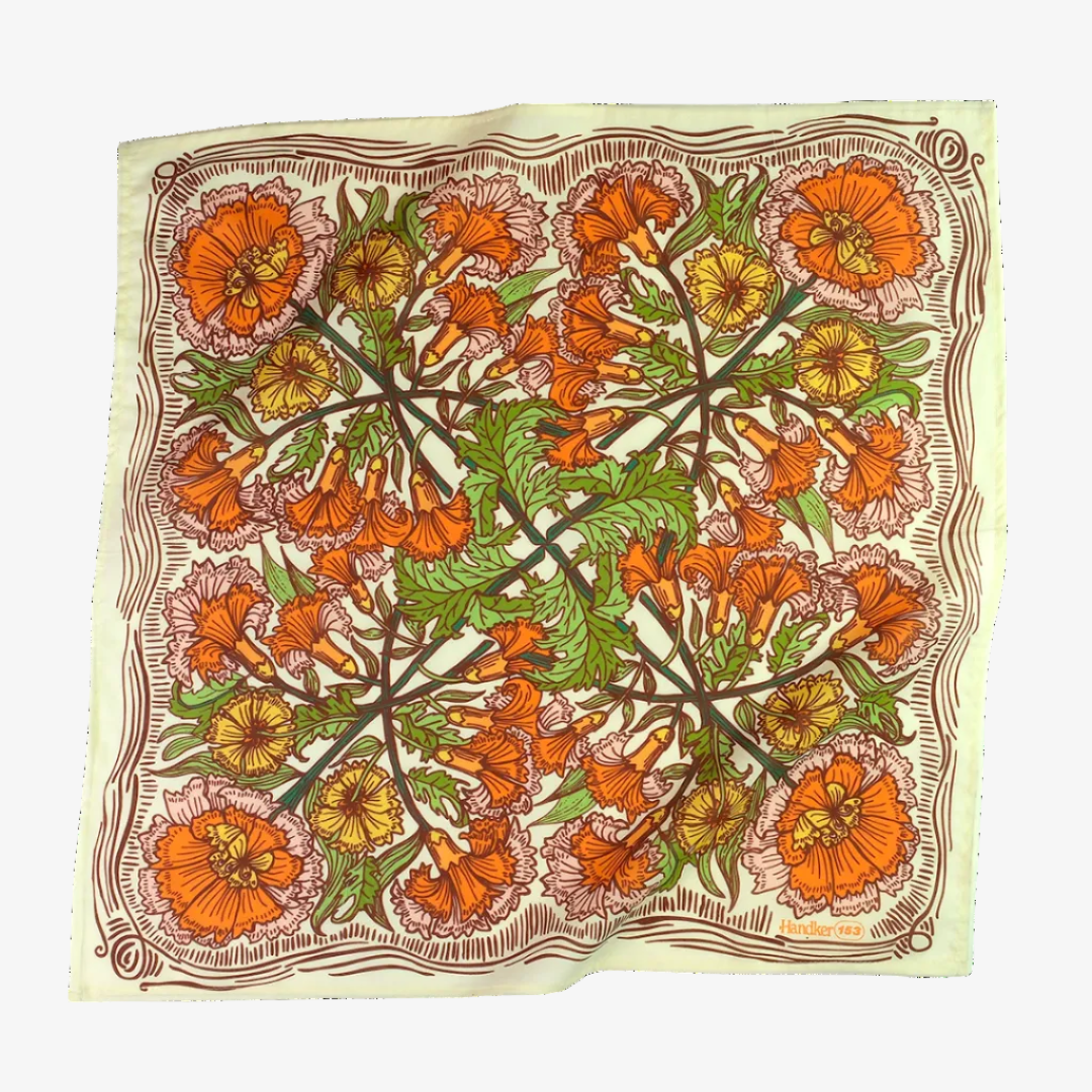 Floral patterned fabric with orange, green, and yellow flowers on a white background