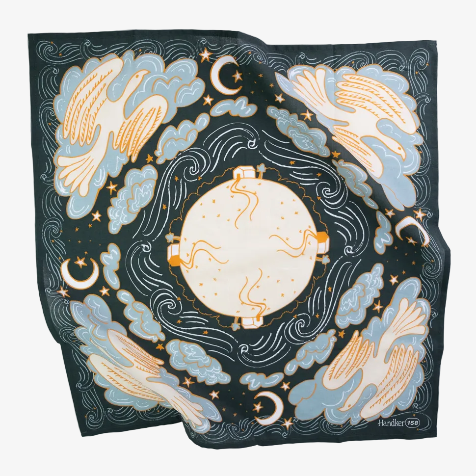 Decorative scarf with celestial design featuring clouds, moon, and stars on a dark background.