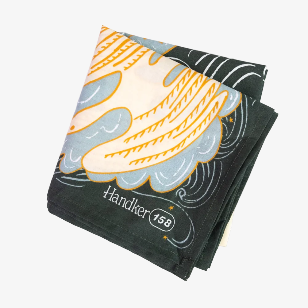 Folded towel with banana design and 'Handler 158' branding on a white background