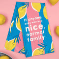 Tea towel with lemon design and text on a pink background
