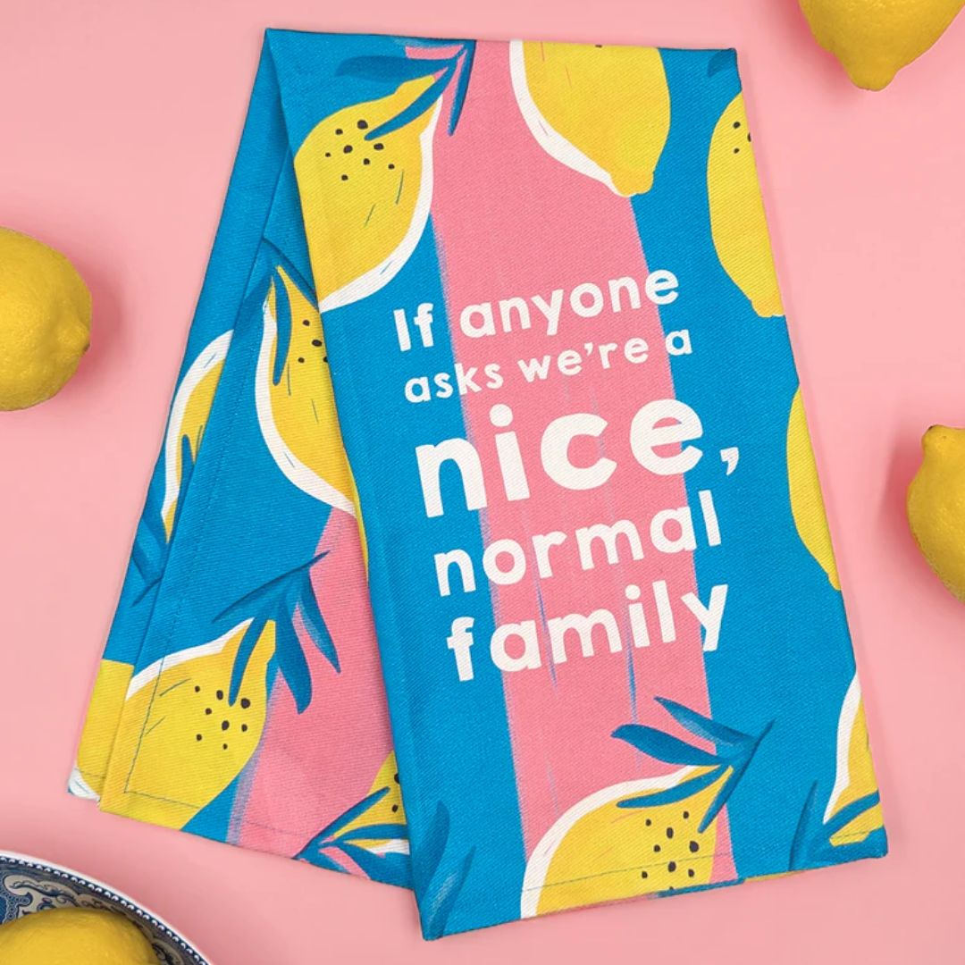Tea towel with lemon design and text on a pink background