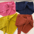 Four knitted scarves in pink, blue, yellow, and brown on a white surface.