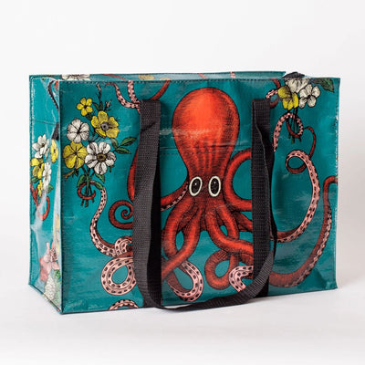 A rectangular shoulder tote bag with black handles, featuring a large red octopus with swirling tentacles against a teal background, surrounded by yellow and white flowers.