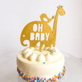 White cake with colorful sprinkles and 'OH BABY' topper on a white background