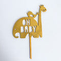 Gold cake topper shaped like a giraffe with 'OH BABY' text on a white background