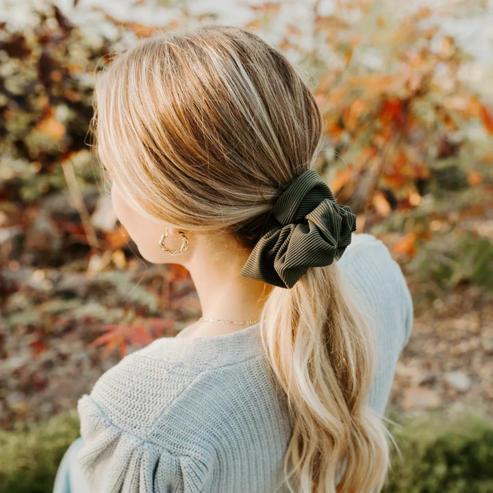 A dark green ribbed scrunchie.
