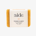 Bar of soap with 'aide' branding on a white background