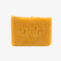 Bar of soap with 'aide' branding on a white background