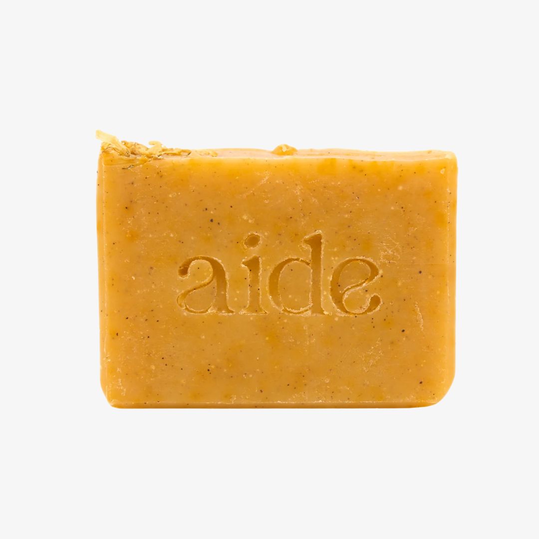 Bar of soap with 'aide' branding on a white background