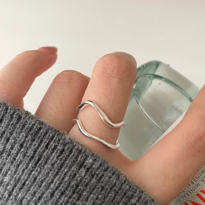 organic shaped adjustable rings, in sterling silver, featuring a fluid, abstract, double wave design, displayed on a white background. These modern rings are available in Ottawa, Ontario, Canada.