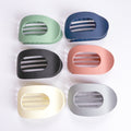 Set of six colorful hair clips on a white background
