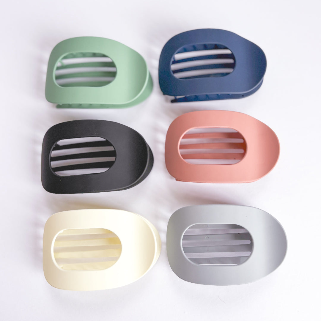 Set of six colorful hair clips on a white background