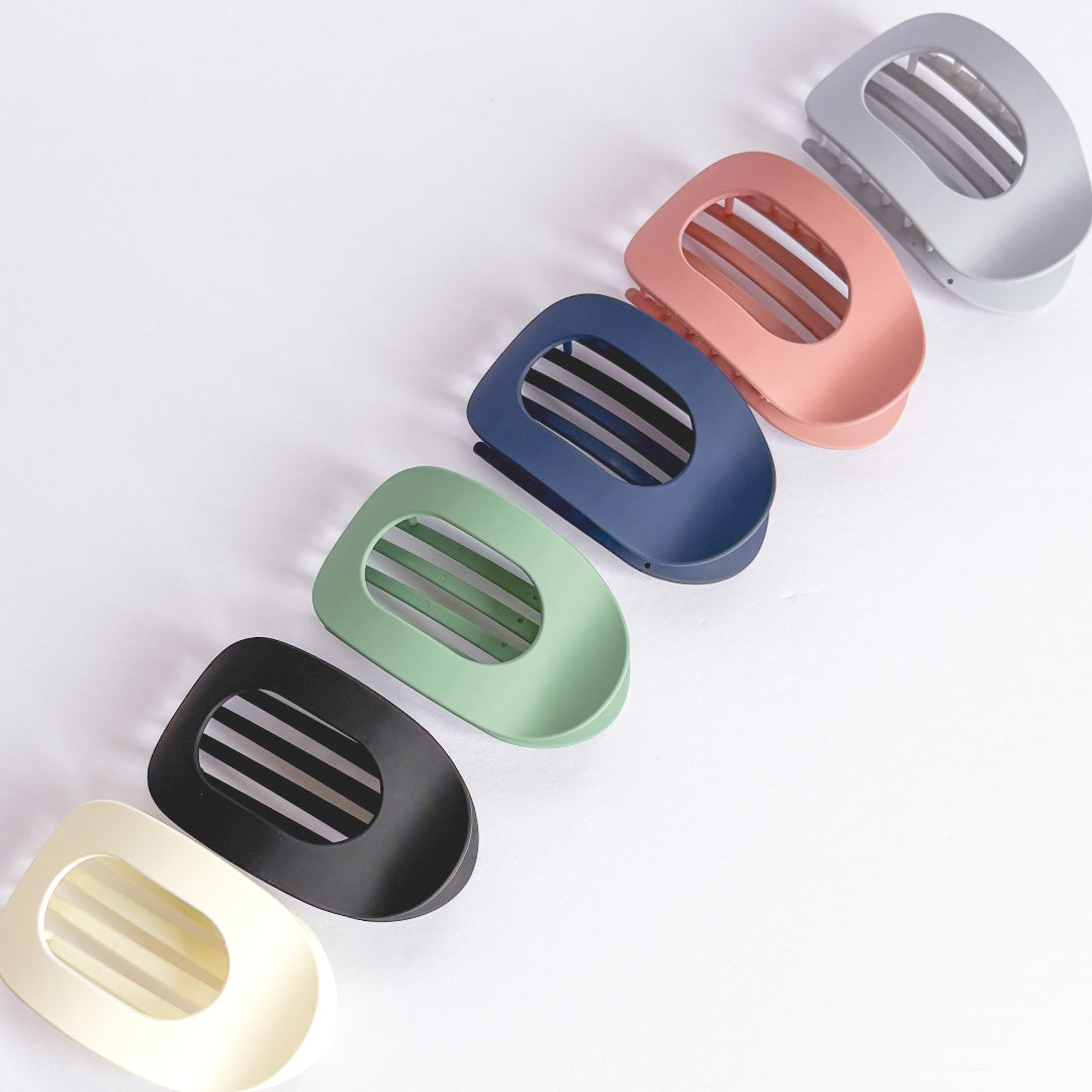 Set of colorful soap dishes on a light gray background