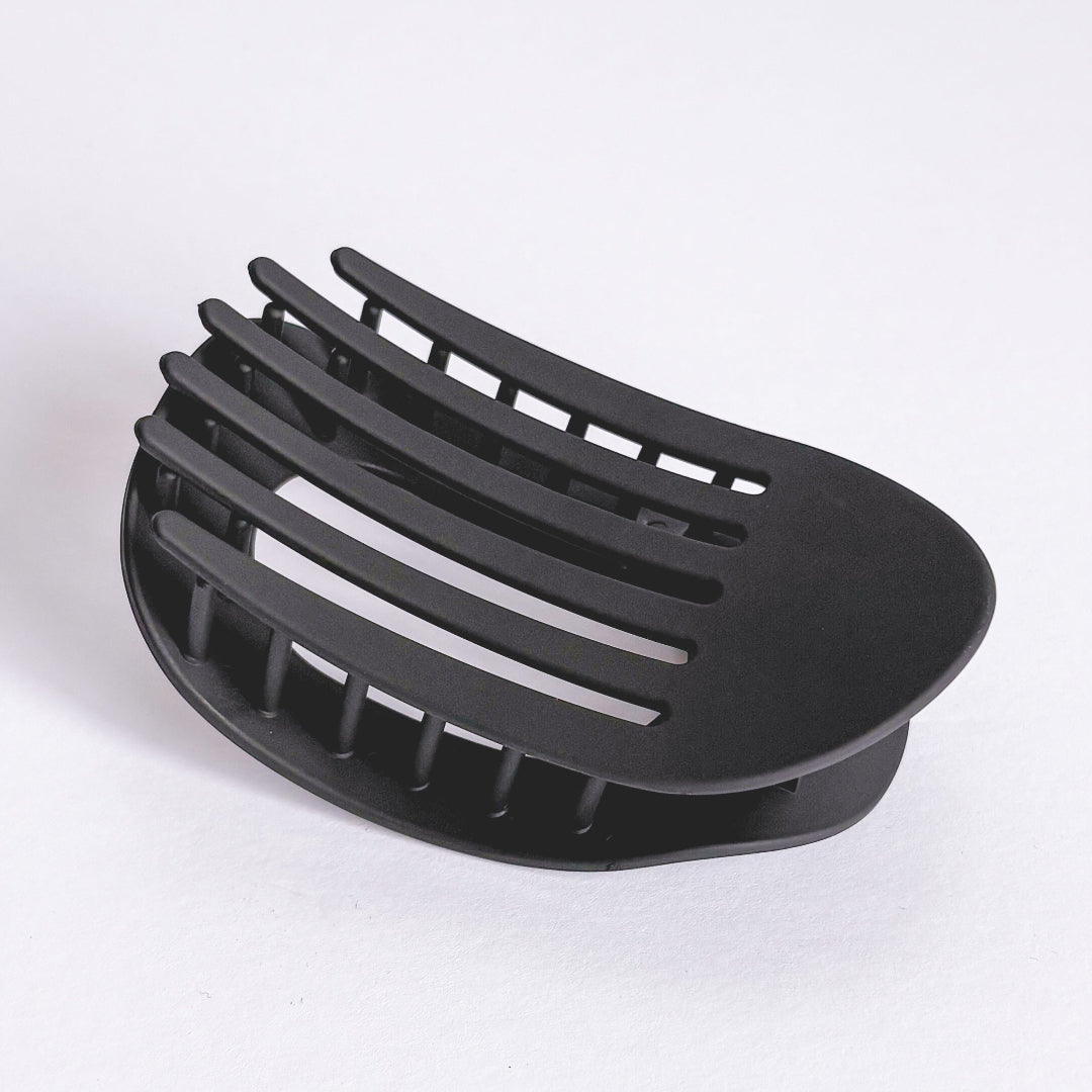 Black plastic component on a white background