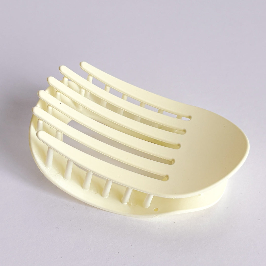 Beige soap dish on a light gray background