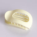 Beige plastic soap holder on a light gray background