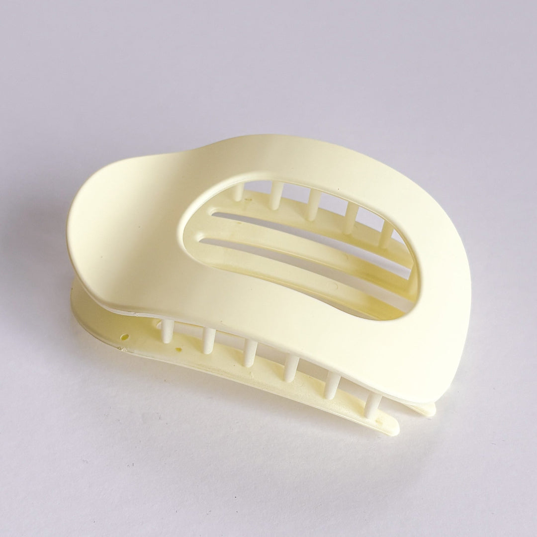 Beige plastic soap holder on a light gray background