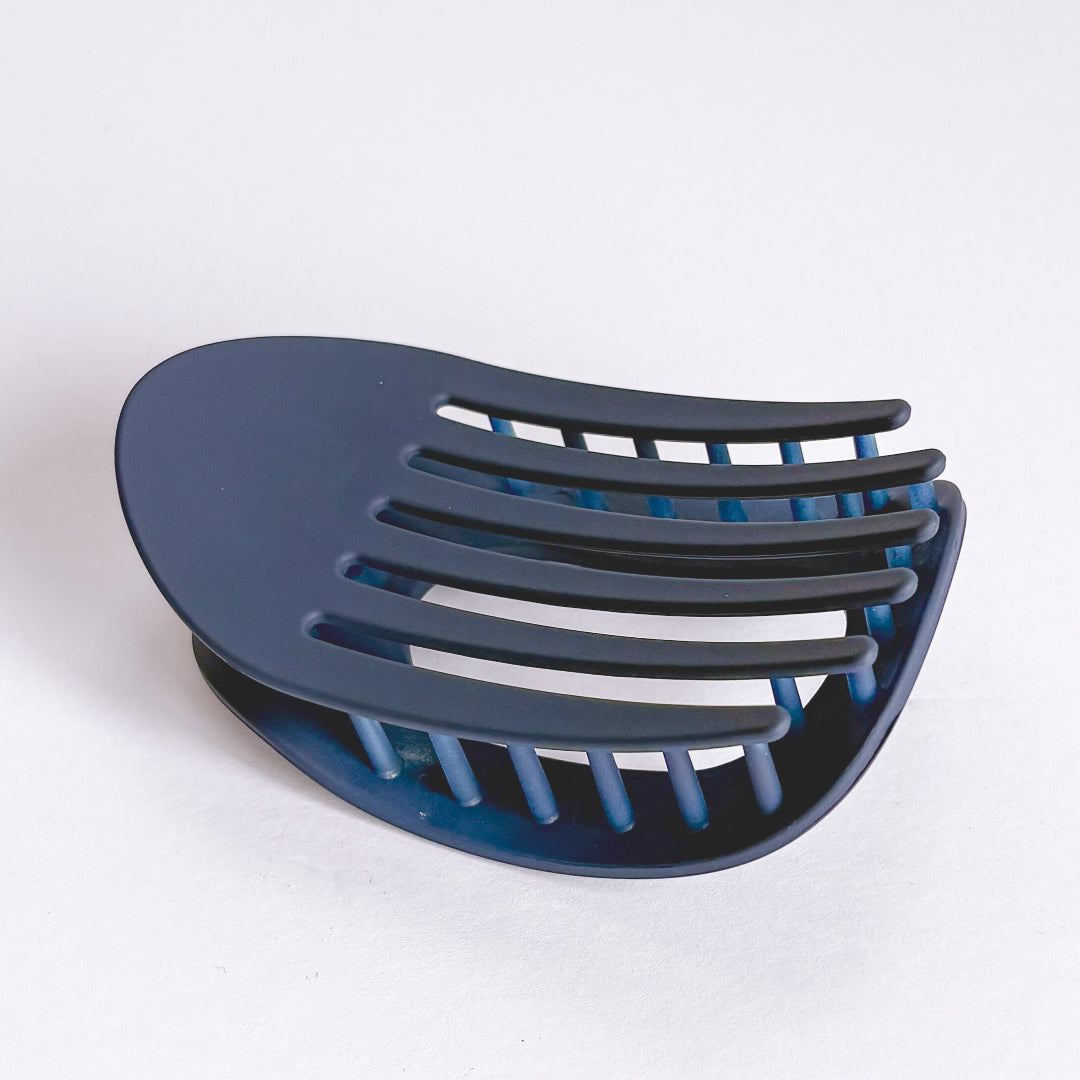 Blue plastic hair scoop on a white background