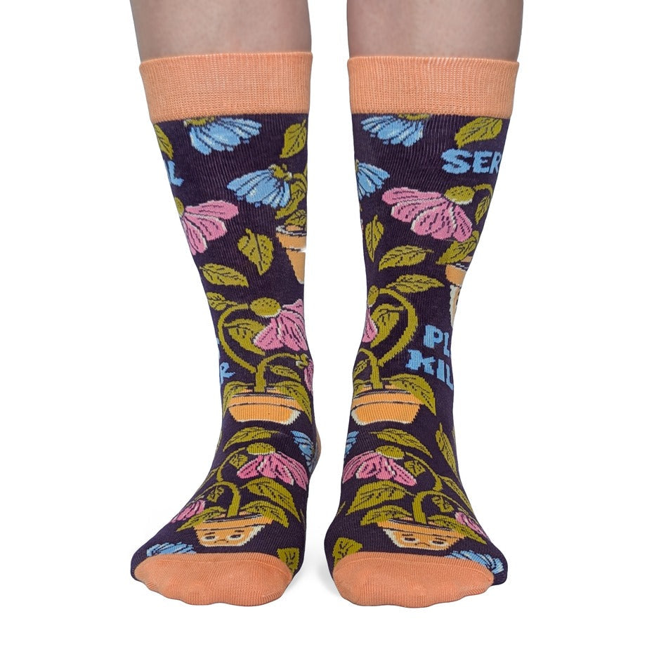 Colorful socks with plant pattern and text on a white background
