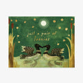 A square art print or card featuring an illustrated green woodland scene with two loons facing each other, small yellow flowers, reeds, and the text 'just a pair of loonies' in a light cream font.