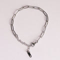 Silver chain bracelet on a light gray background