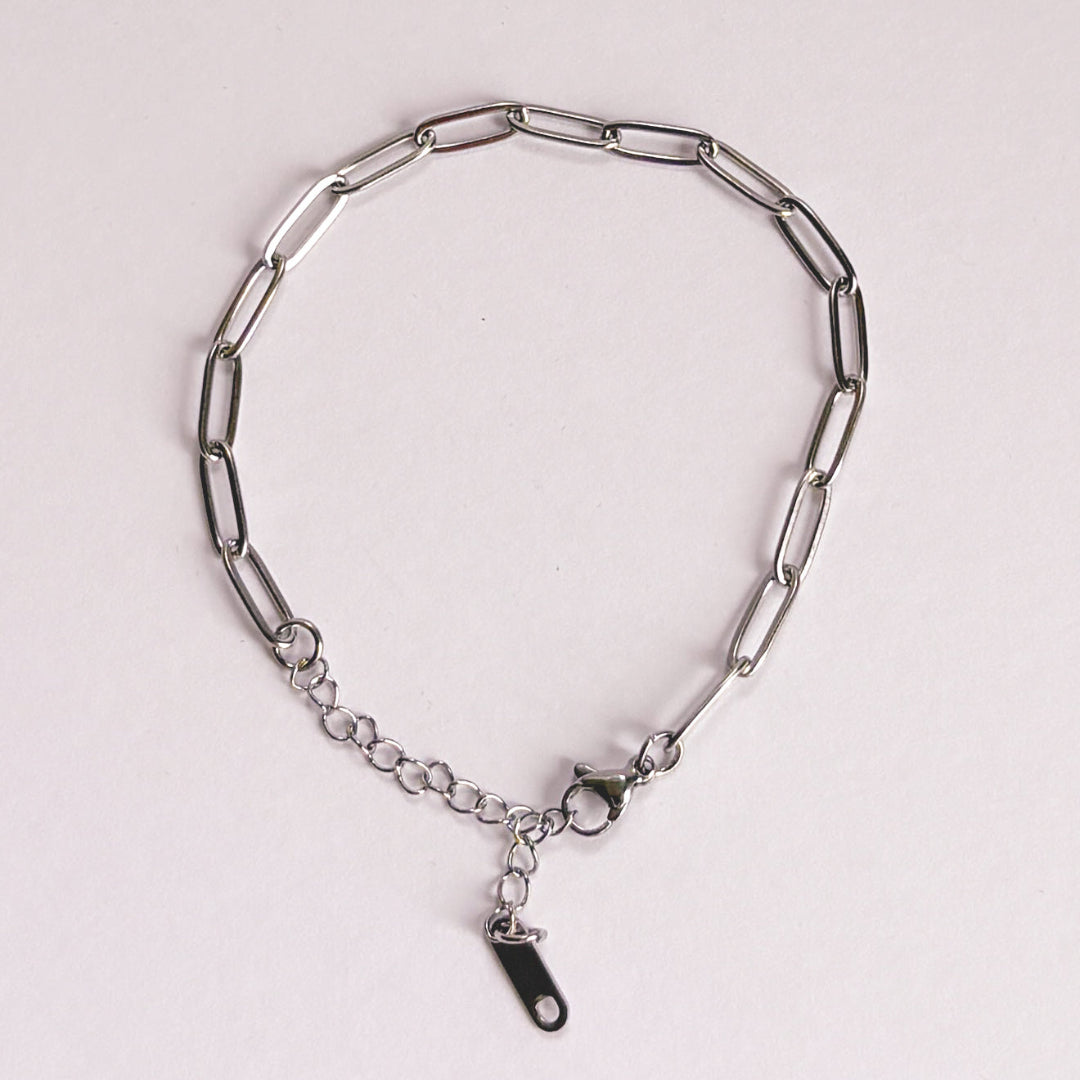Silver chain bracelet on a light gray background