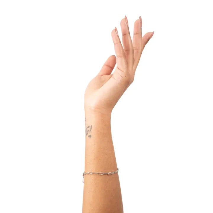  A bracelet is silver-coloured have a chain link design made of small, rectangular links.