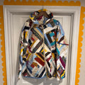 Colorful quilted bag on a white door with yellow trim