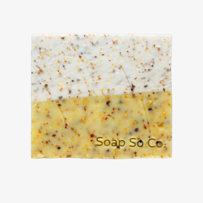 Soap bar with speckled texture and 'Soap So Co' branding on a black background