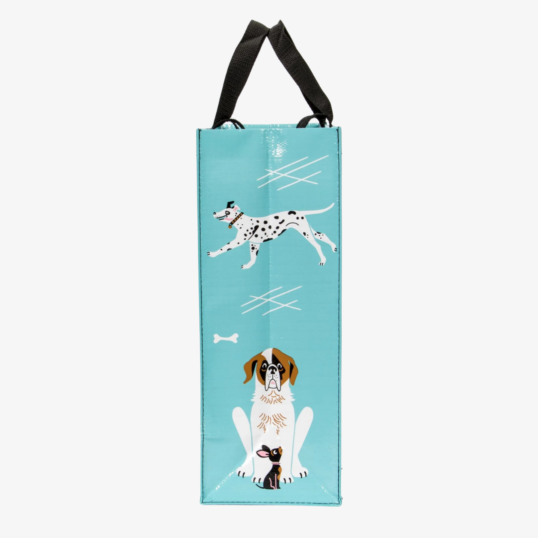 A reusable tote bag with a playful dog-themed design. The bag is a light blue color with black handles. It features a variety of dog breeds in different poses, including a bulldog, a poodle, a dachshund, and a husky. The text "People I want to meet: 1. Dogs" is printed on the bag in black.